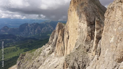 Wallpaper Mural Flying past steep mountain ridge with threatening clouds in the background, Dolomites national park in Italy
 Torontodigital.ca