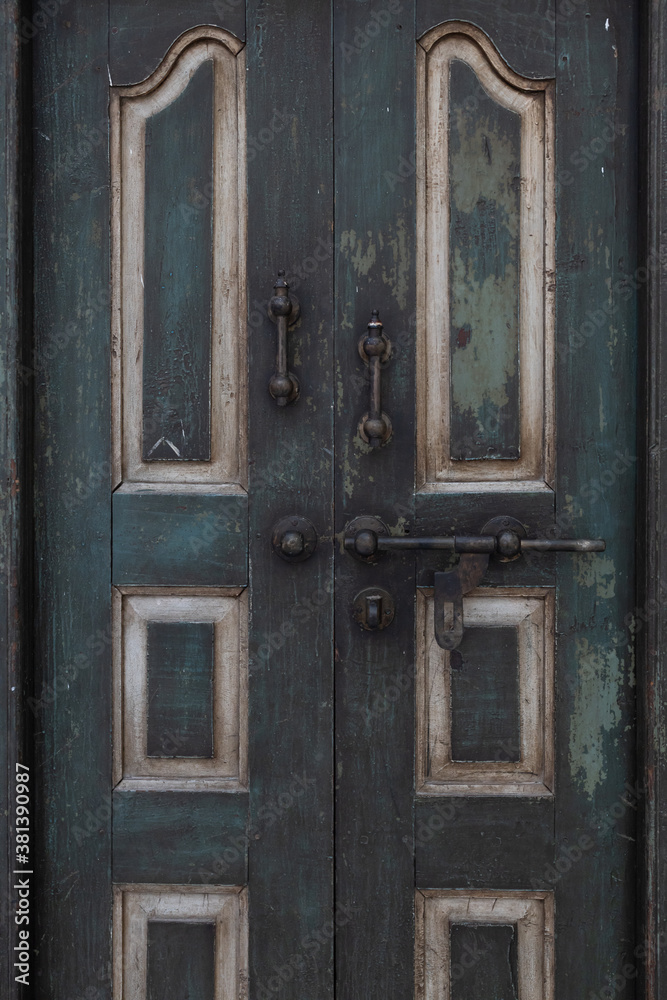 close up view of ancient wooden door with rusty old slide or tower bolt