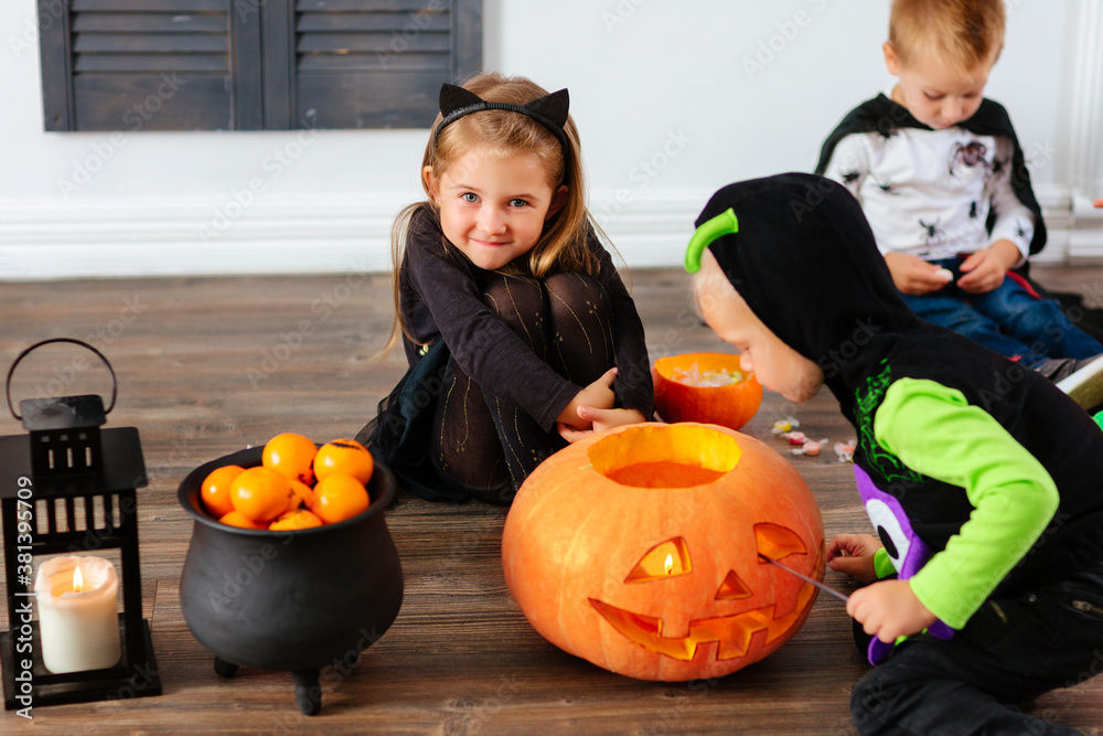 Fototapeta premium Kids in carnival costumes are celebrating Halloween