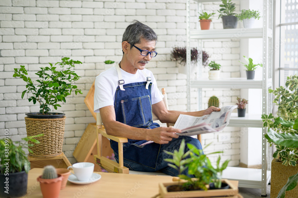 An elderly man is relaxing with coffee and reading Newspaper at his home . An elderly man is relaxing with coffee and reading Newspaper at his home .