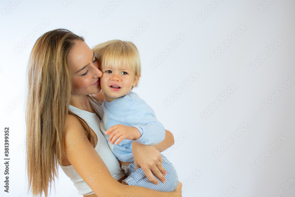 A sister holding her baby brother on white background