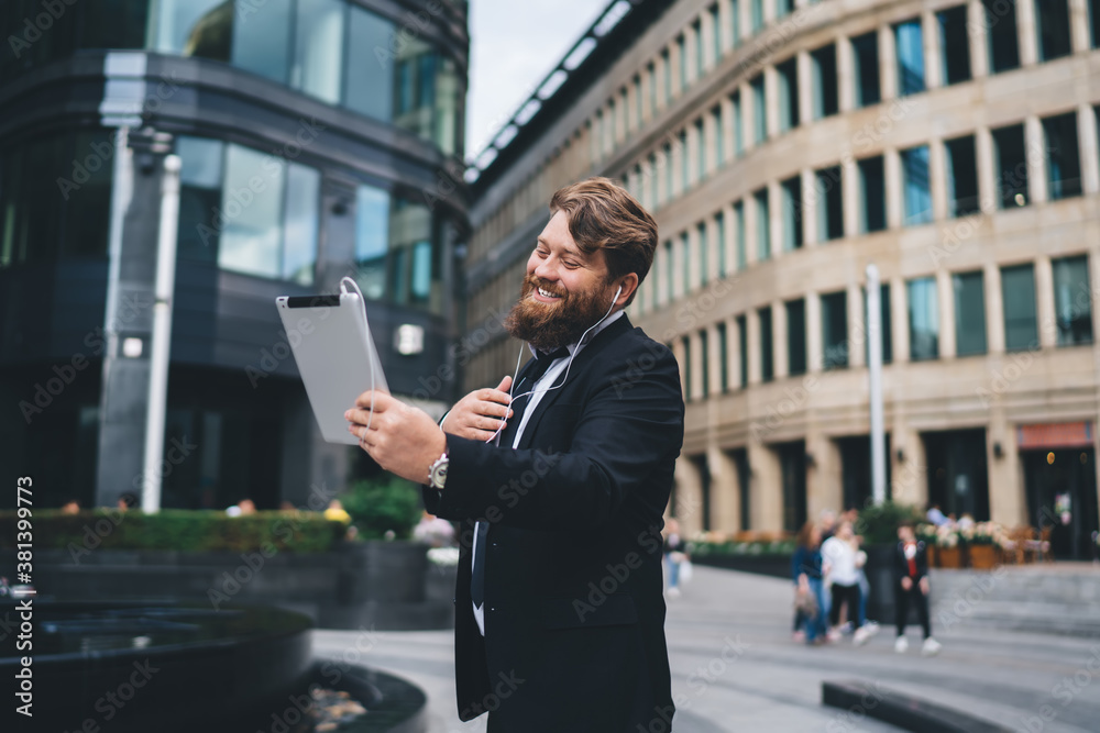 Cheerful young man with bushy beard having video call Cheerful young man with bushy beard having video call