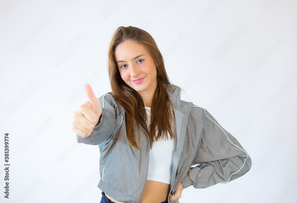 portrait of attractive smile teenage girl show thumbs up gesture, isolated over white background portrait of attractive smile teenage girl show thumbs up gesture, isolated over white background