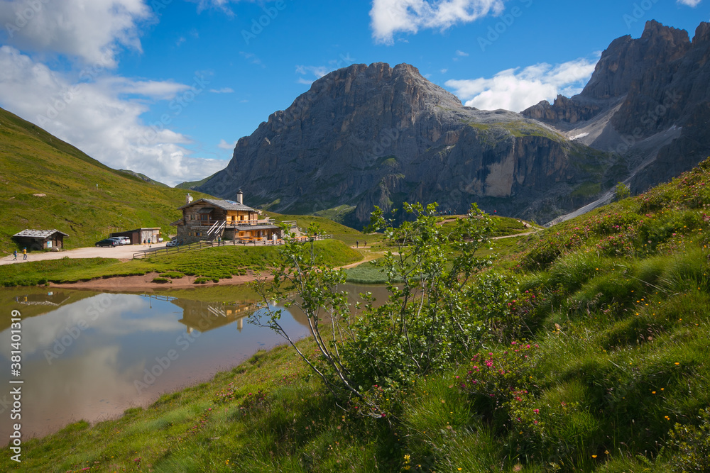 Majestic morning scene of Baita Segantini mountain refuge with Cimon della Pala peak. Summer view of Dolomiti Alps, Rolle pass, Trentino province, Italy, Europe. Traveling concept background