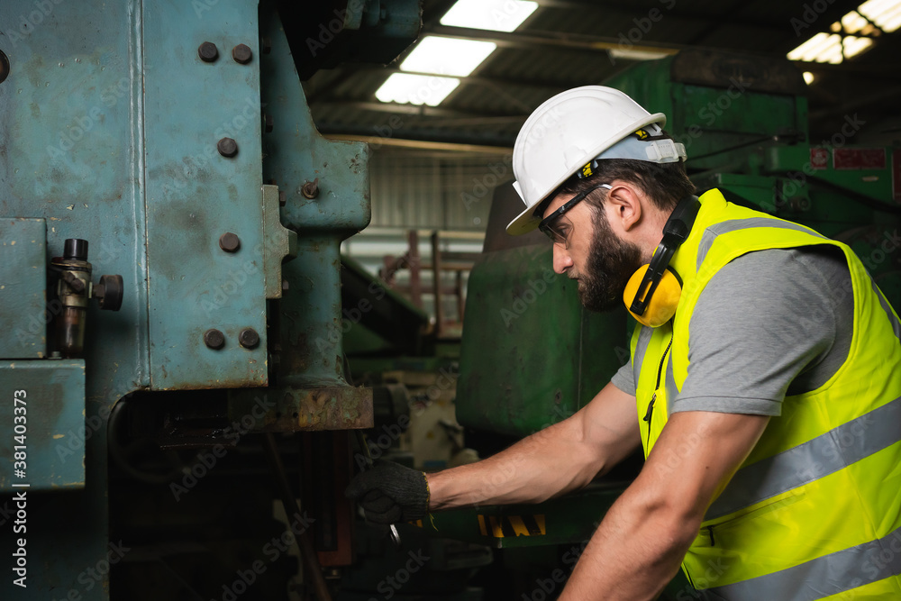 Engineer working at industrial machinery in factory. Manual workers cooperating while measuring a electronic. Engineer working at industrial machinery in factory. Manual workers cooperating while measuring a electronic.