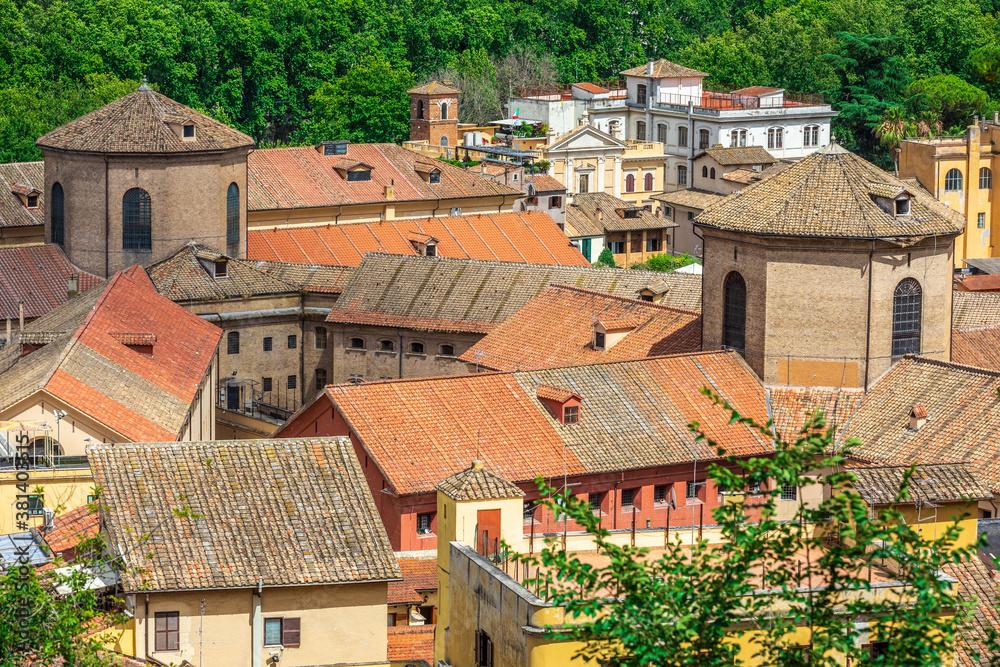 Roofs of Rome in Italy. Aerial view of the rooftop houses in the historic center of the Italian capital. Tiles and pitched roofs. Gianicolense Trastevere area.