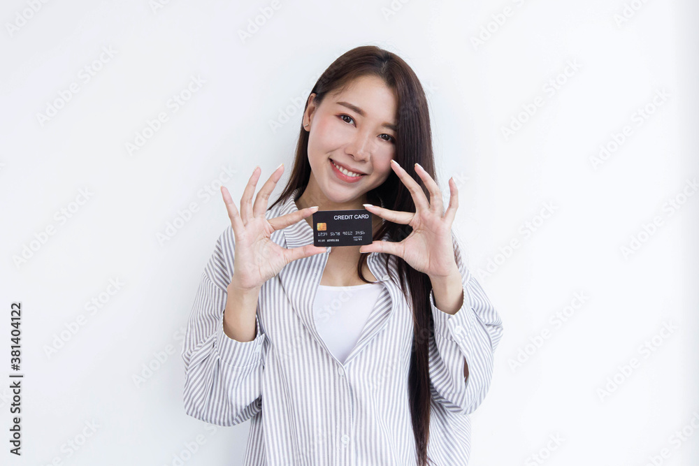 A beautiful woman standing with a credit card For online shopping. A beautiful woman standing with a credit card For online shopping.