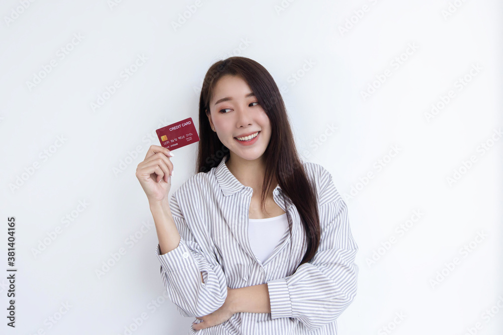 A beautiful woman standing with a credit card For online shopping. A beautiful woman standing with a credit card For online shopping.