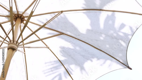 Handmade white cotton Asian garden umbrella made of bamboo wood in Thailand