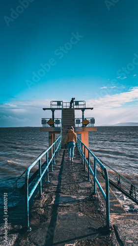 woman walking up to Blackrock diving board Galway