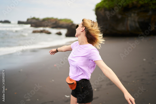 Happy woman dancing on beach