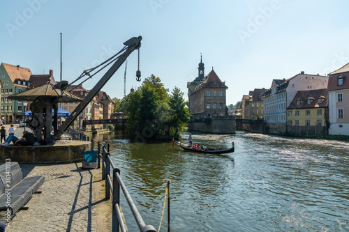 the Regnitz river in Bamberg with a gondolieri and the old harbor crane