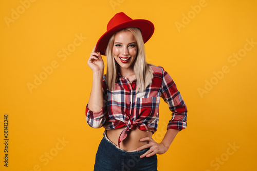 Image of cheerful beautiful pinup girl posing in red hat