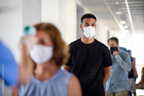 Portrait of people with face masks waiting, coronavirus, covid-19 and vaccination concept.