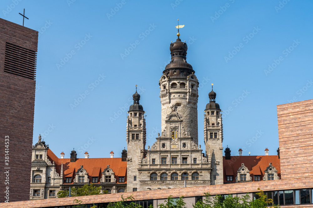 the old city hall building in Leipzig with the church of St. Trinitatis in the foreground