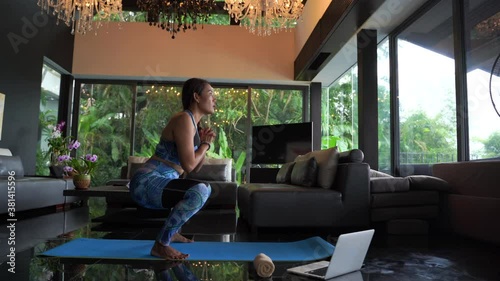 Wallpaper Mural workout form home woman in sportswear and is using a laptop at home in the living room. Sport and recreation concept. Torontodigital.ca