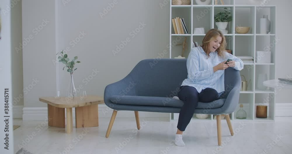 Portrait of happy business woman enjoy success on mobile phone at home office. Closeup joyful girl reading good news on phone in slow motion. Surprised lady celebrating victory on phone in apartment. Portrait of happy business woman enjoy success on mobile phone at home office. Closeup joyful girl reading good news on phone in slow motion. Surprised lady celebrating victory on phone in apartment.