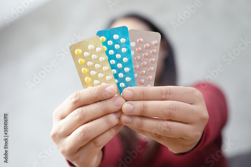 Women carry birth control pills, focus Hand
