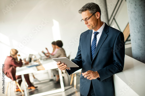 Handsome businessman using ...