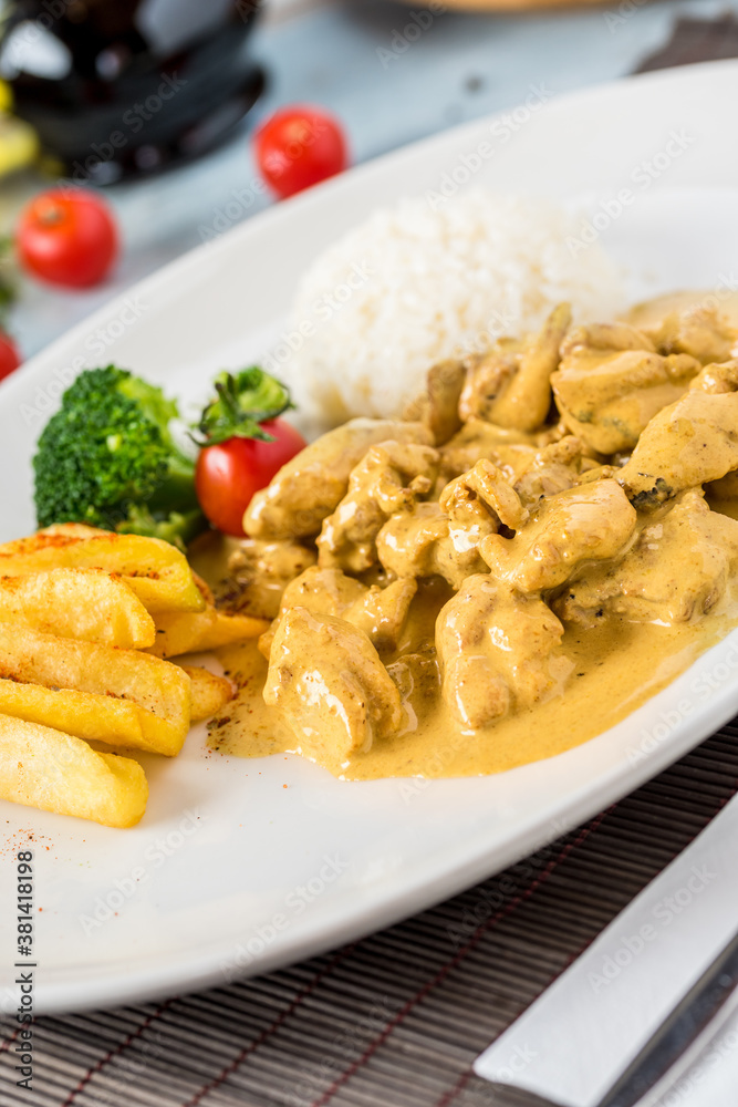 Chicken Curry Sauce. Served with rice. Natural wooden background. Chicken Curry Sauce. Served with rice. Natural wooden background.