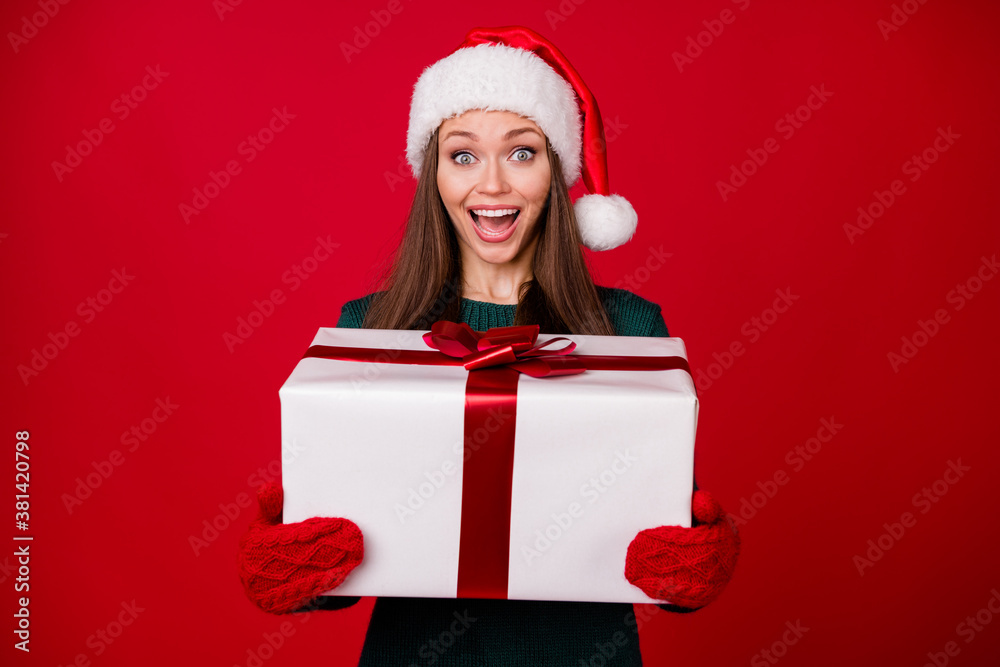 Portrait of her she nice attractive charming pretty glad cheerful cheery girl holding in hands big giftbox having fun isolated over bright vivid shine vibrant red color background Portrait of her she nice attractive charming pretty glad cheerful cheery girl holding in hands big giftbox having fun isolated over bright vivid shine vibrant red color background