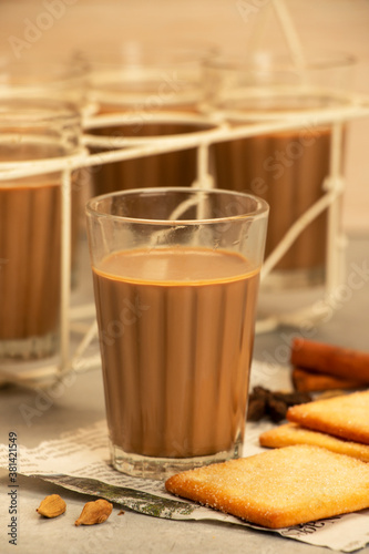 Indian Cutting Chai or Masala Tea with Spices Served in Glasses in a Roadside Shop photo