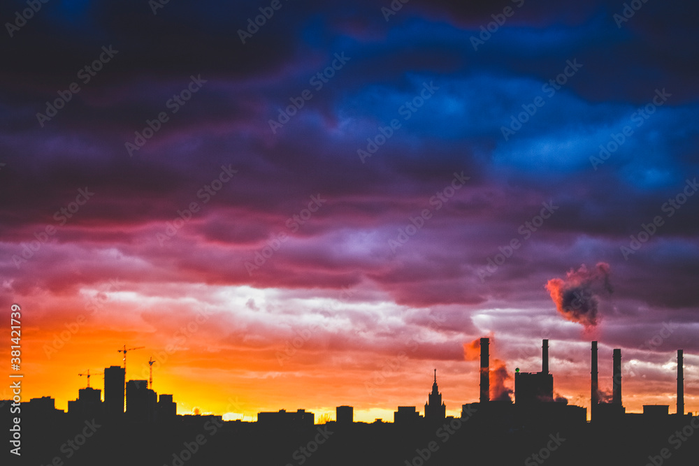 Moscow city silhouette over dramatic cloudy sky at sunset