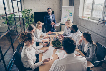Photo of business people sharks gathering sit table desk listen investor talk company growth way-out crisis strategy in workplace workstation