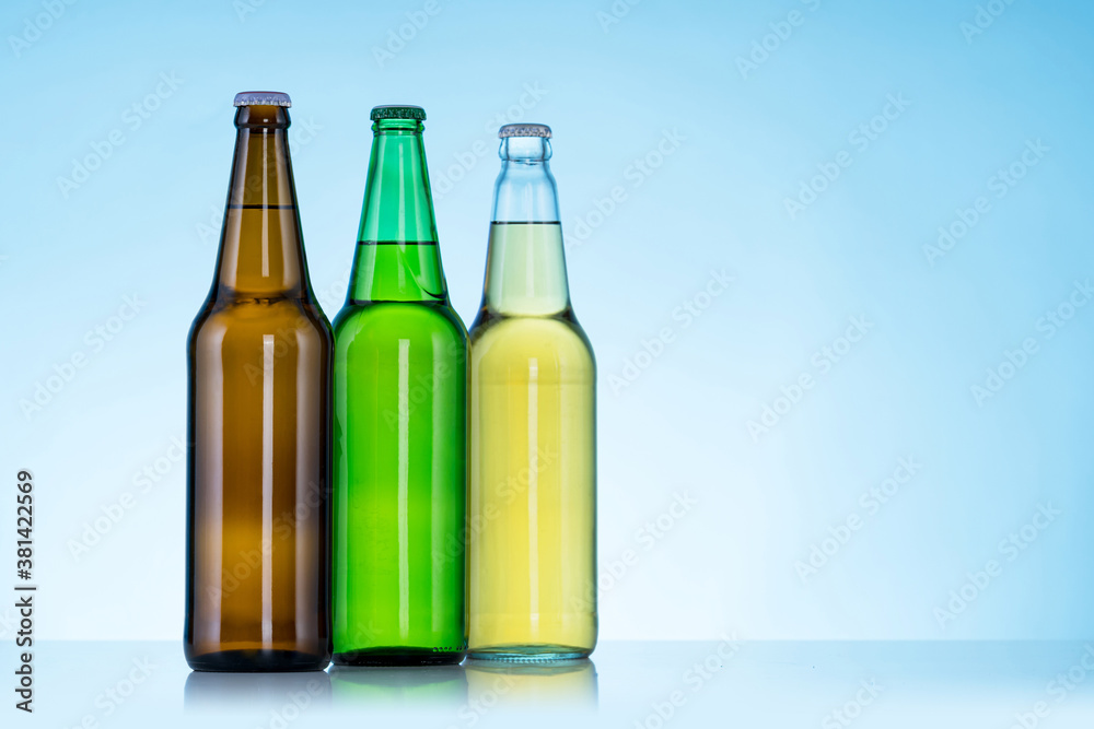 Group of Three bottles of beer on blue background