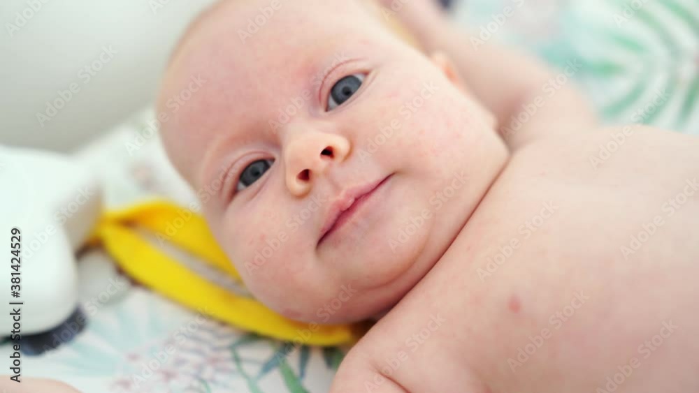 close up face. beautiful red-haired baby lies on a white bed. close up face. beautiful red-haired baby lies on a white bed.