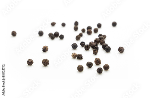 Black pepper, herbs, spices in top view.