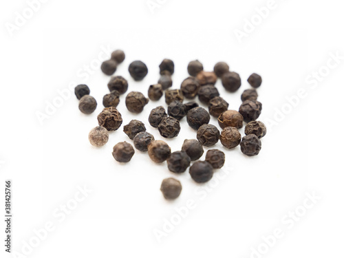 Black pepper, herbs, spices in top view.