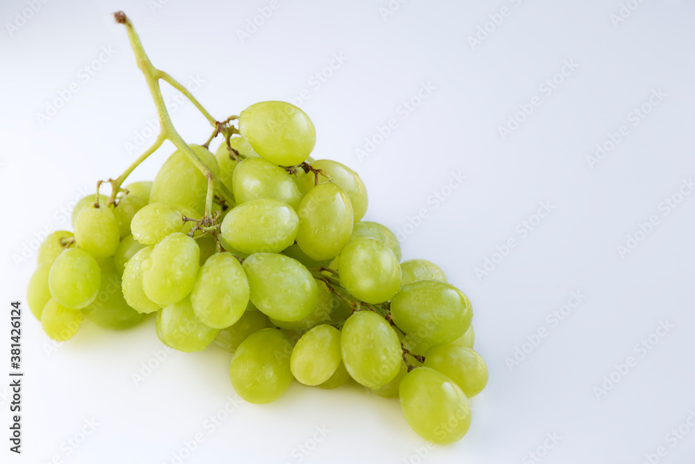 Bunch of green grapes isolated on the white background with copy space