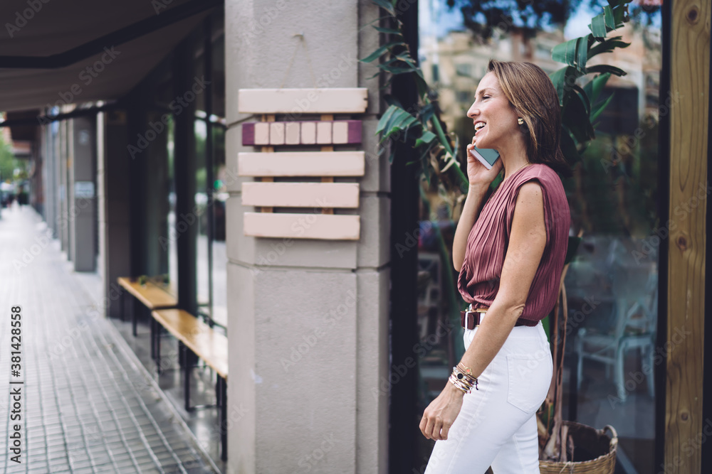 Smiling woman talking on smartphone on street Smiling woman talking on smartphone on street