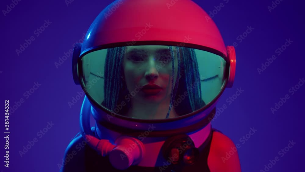Woman in space helmet. Multi-colored neon lighting. Woman in space helmet. Multi-colored neon lighting.