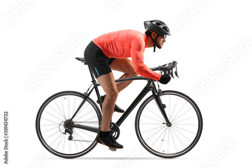 Fototapeta Naklejka Na Ścianę i Meble - Profile shot of a male cyclist riding a road bicycle with spinning wheels