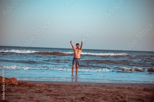Man at beach greeting