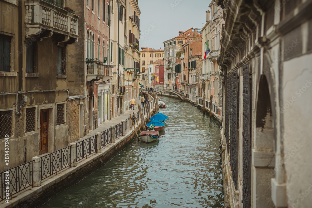 Empty canals in venice during a cloudy day, also affected by a loss of tourists due to covid-19 crisis.