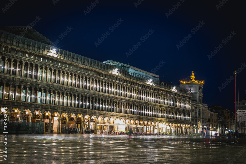 Olivetti exhibition centre on piazza San Marco in Venice, Italy during a rainy night time, with reflections on the floor.