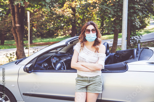 Attractive young woman wearing protective medical mask against c © mitarart