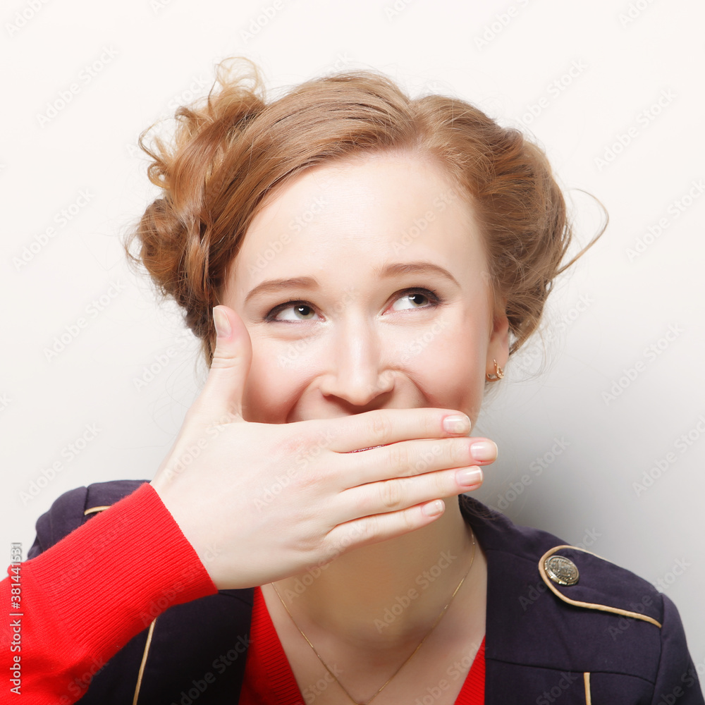 young woman covering the face with her hand young woman covering the face with her hand