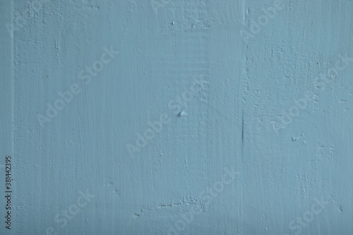 Old rough, uneven surface painted blue.