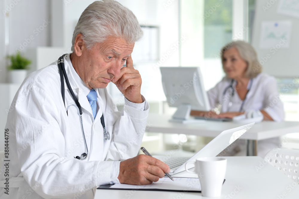 Portrait of male doctor working at desk