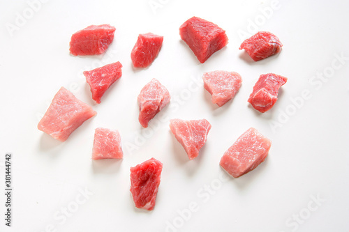 raw beef and veal pieces on white background