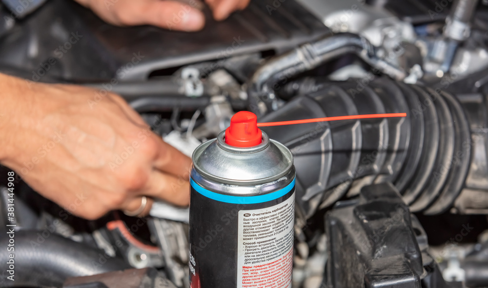 Obraz premium Repairman Working and fixing car engine at service shop. Mechanic man hands repair and overhaul car engine.