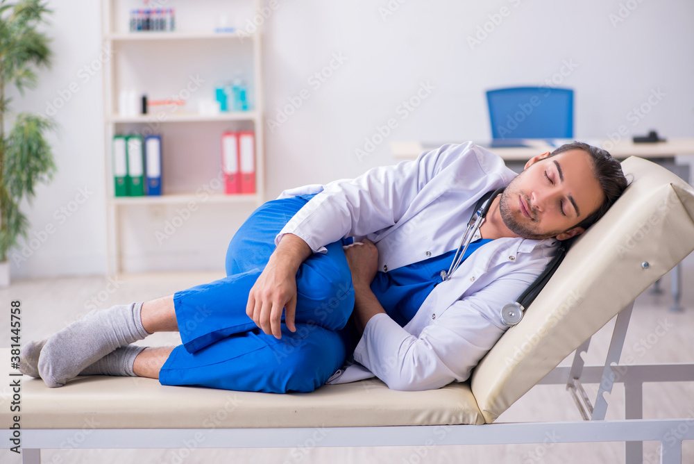 Young male doctor being tired after night shift Young male doctor being tired after night shift