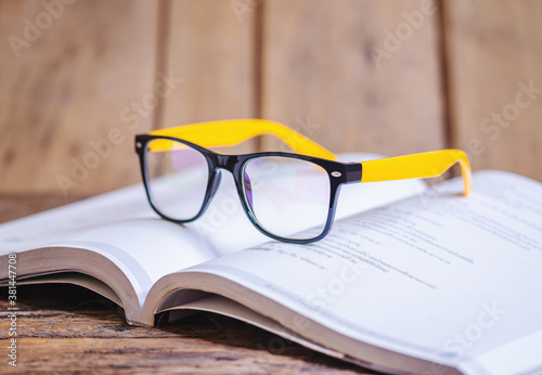 Glasses on the book blurred background