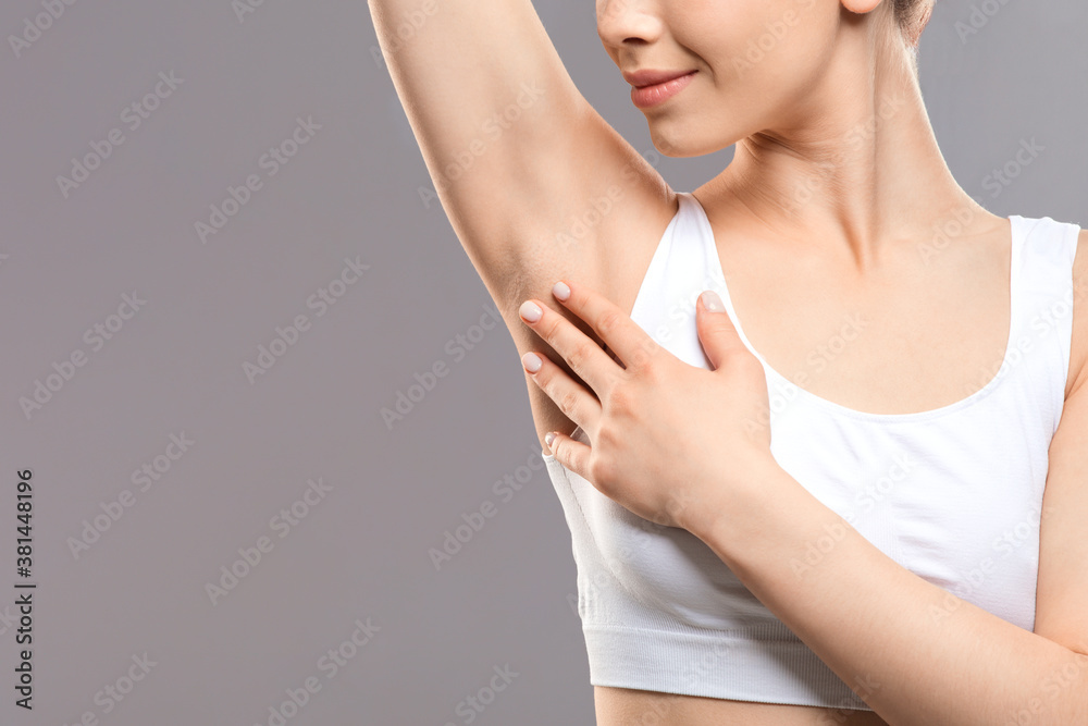 Unrecognizable woman touching her armpit, copy space