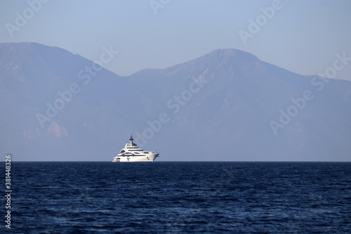 View from the sea to the mountain islands and luxury yacht. Picturesque seascape, travel and vacation concept