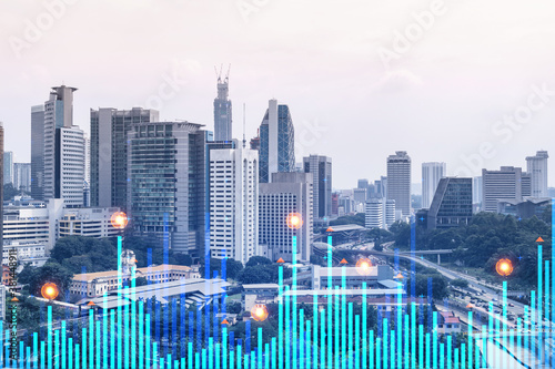Financial stock chart hologram over panorama city view of Kuala Lumpur. KL is the business center in Malaysia, Asia. The concept of international transactions. Double exposure.